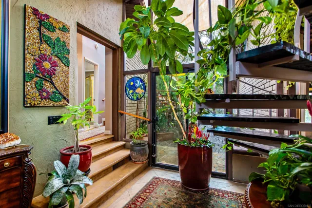 a living room with furniture and a potted plant