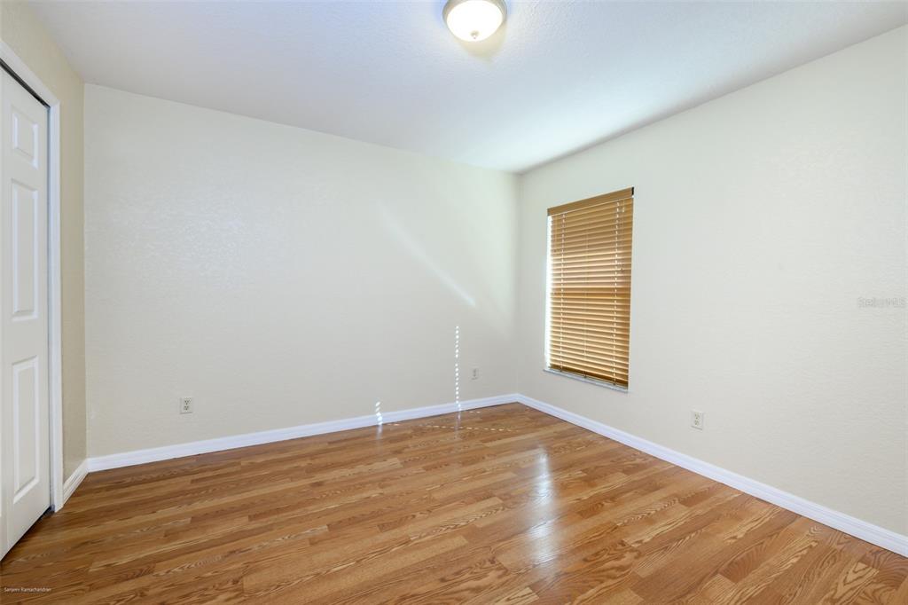 311 Goiana Street Punta Gorda, FL 33983 - Photo 38 of 40 a view of an empty room with wooden floor and a window