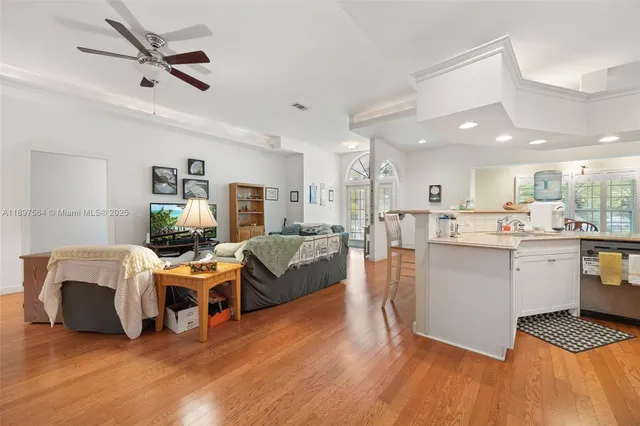 a living room with furniture and a wooden floor