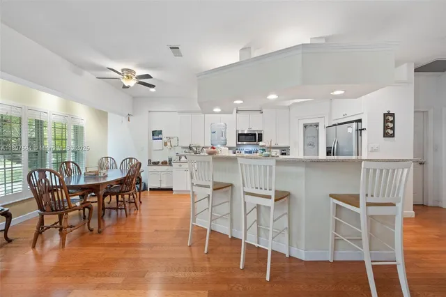 a view of a dining room with furniture and wooden floor
