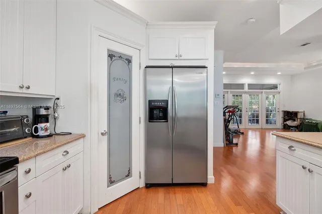 a kitchen with stainless steel appliances granite countertop a refrigerator and a stove top oven