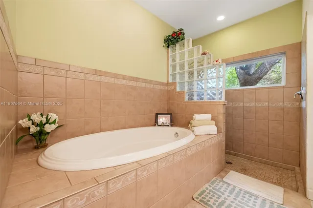 a bath room with a white bath tub and a shower