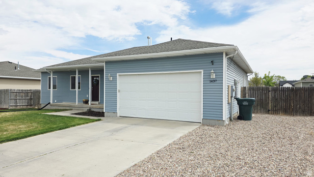 1437 925 South Vernal, UT 84078 - Photo 40 of 47 Ranch-style residence featuring light blue siding, an attached two-car garage, and a covered front porch