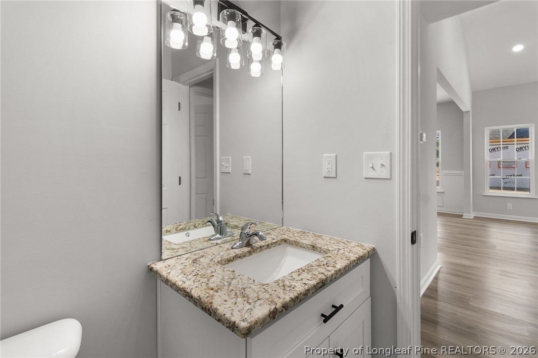 802 Holmes Street Clinton, NC 28328 - Photo 22 of 31 a bathroom with a granite countertop sink and a mirror
