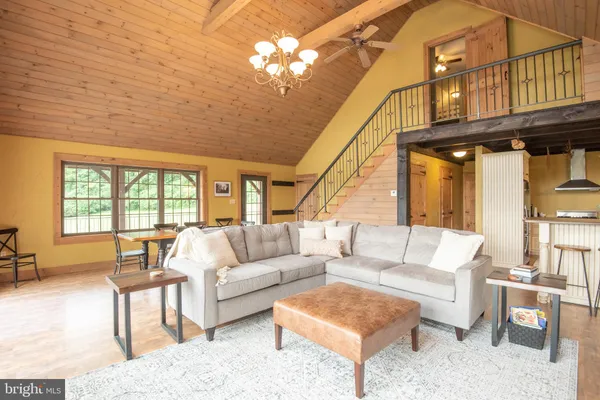 a living room with furniture a fireplace and a table