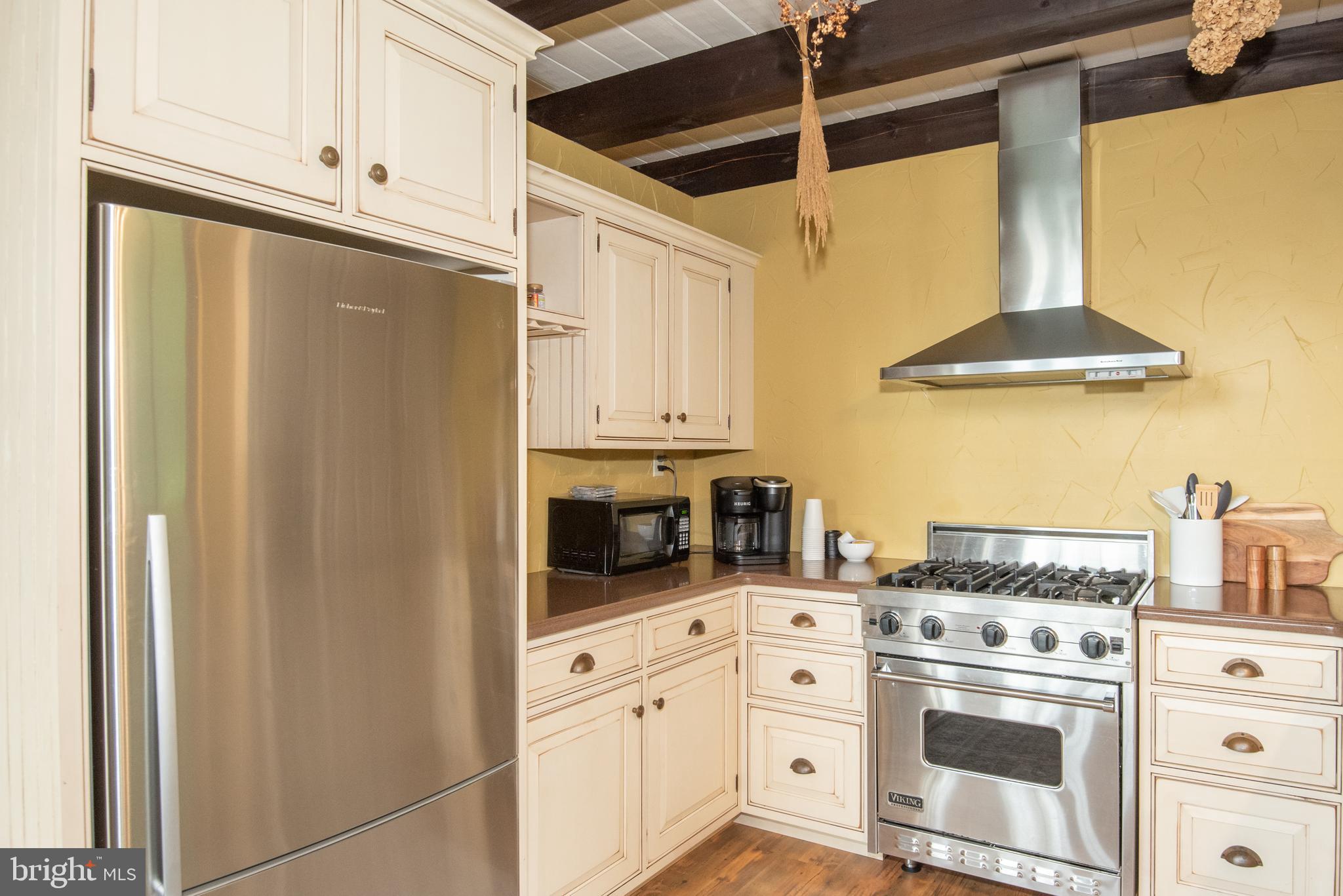300 Beegle Road Everett, PA 15537 - Photo 16 of 114 a kitchen with stainless steel appliances a stove a refrigerator and cabinets