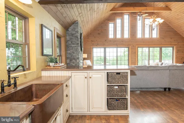 a view of a patio with table and chairs with wooden floor and fence
