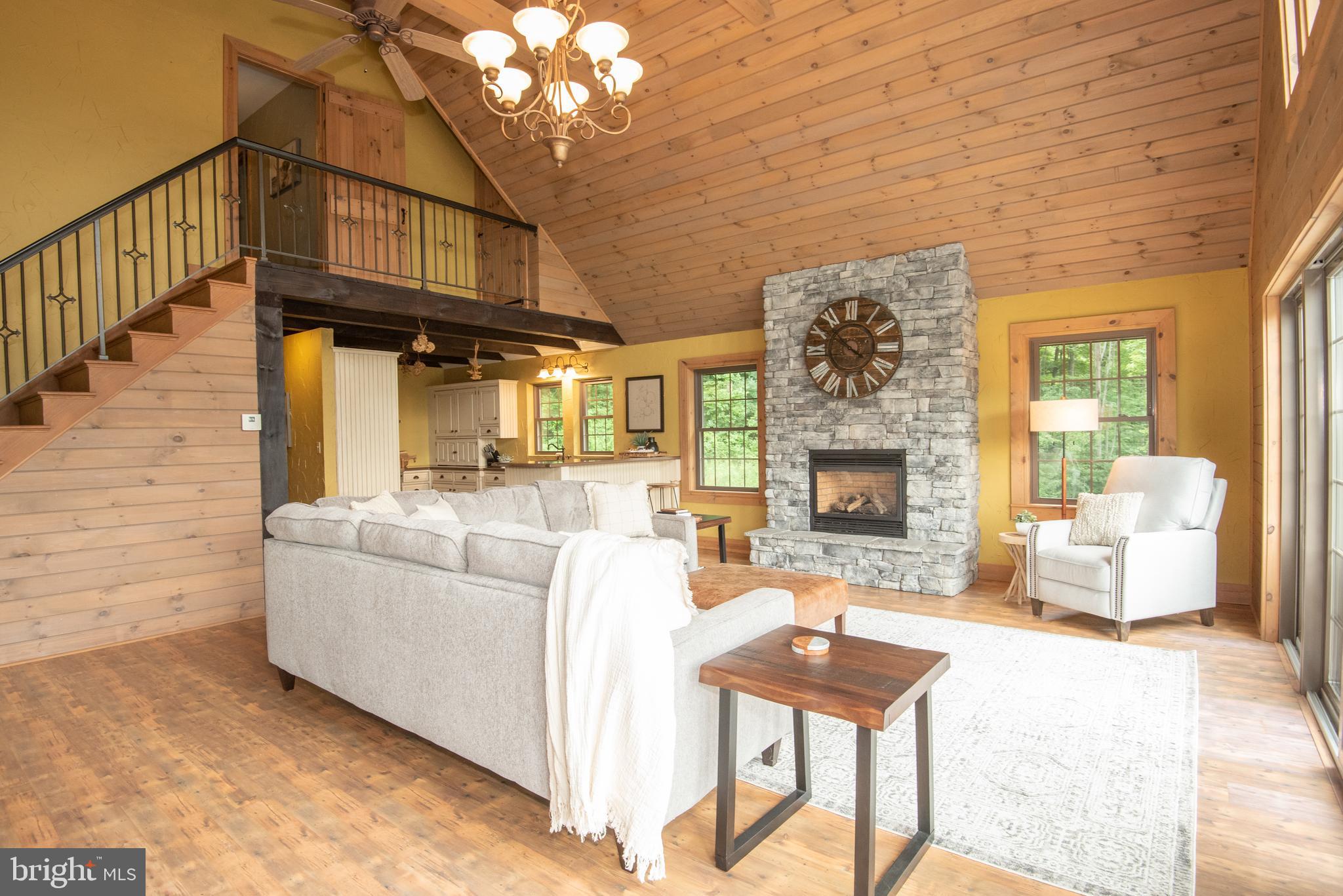 300 Beegle Road Everett, PA 15537 - Photo 19 of 114 a living room with furniture a fireplace and a table