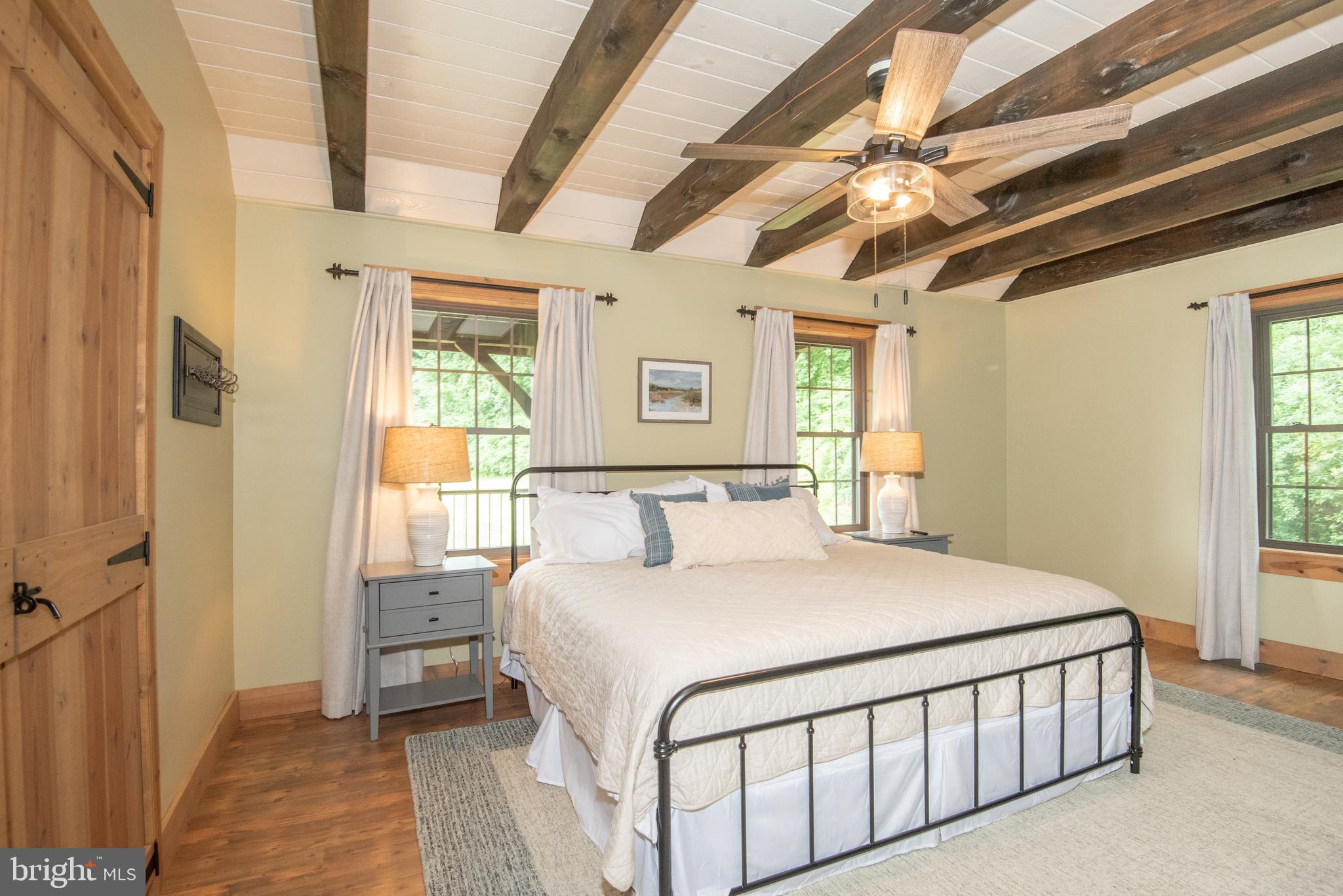 300 Beegle Road Everett, PA 15537 - Photo 20 of 114 a bedroom with a large bed and a chandelier