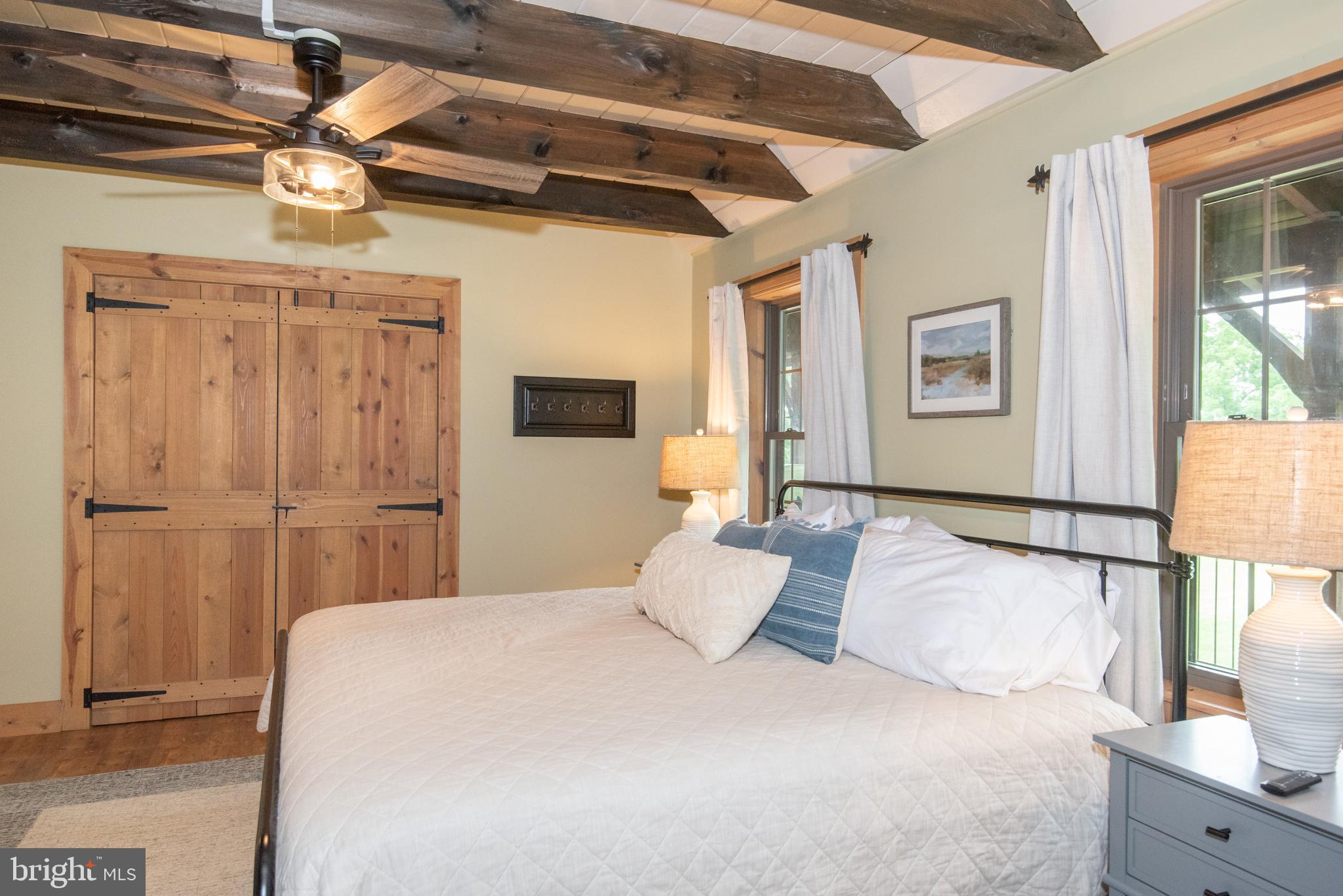 300 Beegle Road Everett, PA 15537 - Photo 22 of 114 a bedroom with a large bed and a chandelier