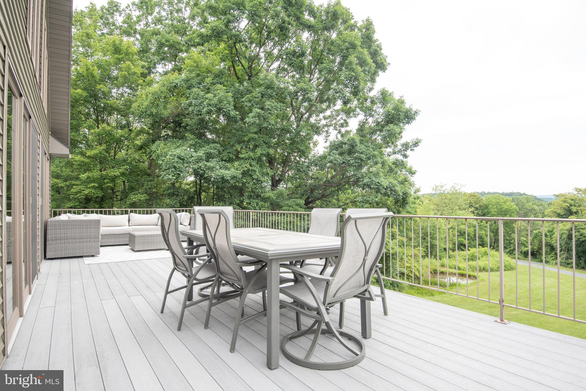 300 Beegle Road Everett, PA 15537 - Photo 26 of 114 a view of a deck with table and chairs and wooden floor