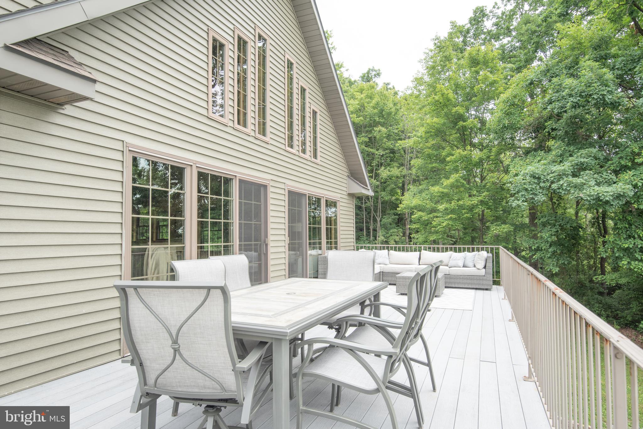 300 Beegle Road Everett, PA 15537 - Photo 27 of 114 a view of a patio with table and chairs with wooden floor and fence