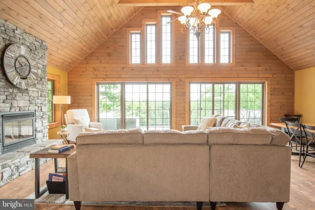 a living room with furniture a dining table and a chandelier