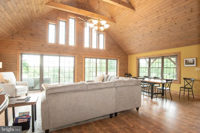 a kitchen with granite countertop a stove a sink dishwasher and white cabinets with wooden floor