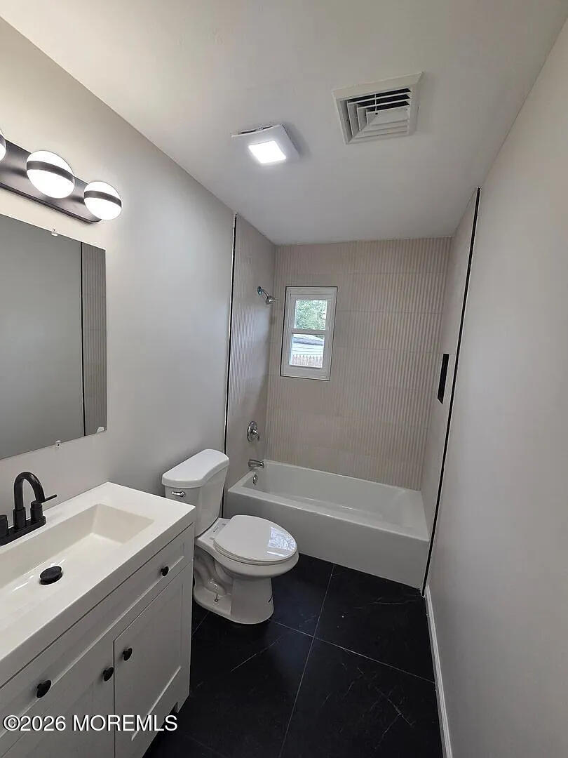 3 Freewood Street Howell, NJ 07731 - Photo 7 of 9 a bathroom with a sink a toilet and shower