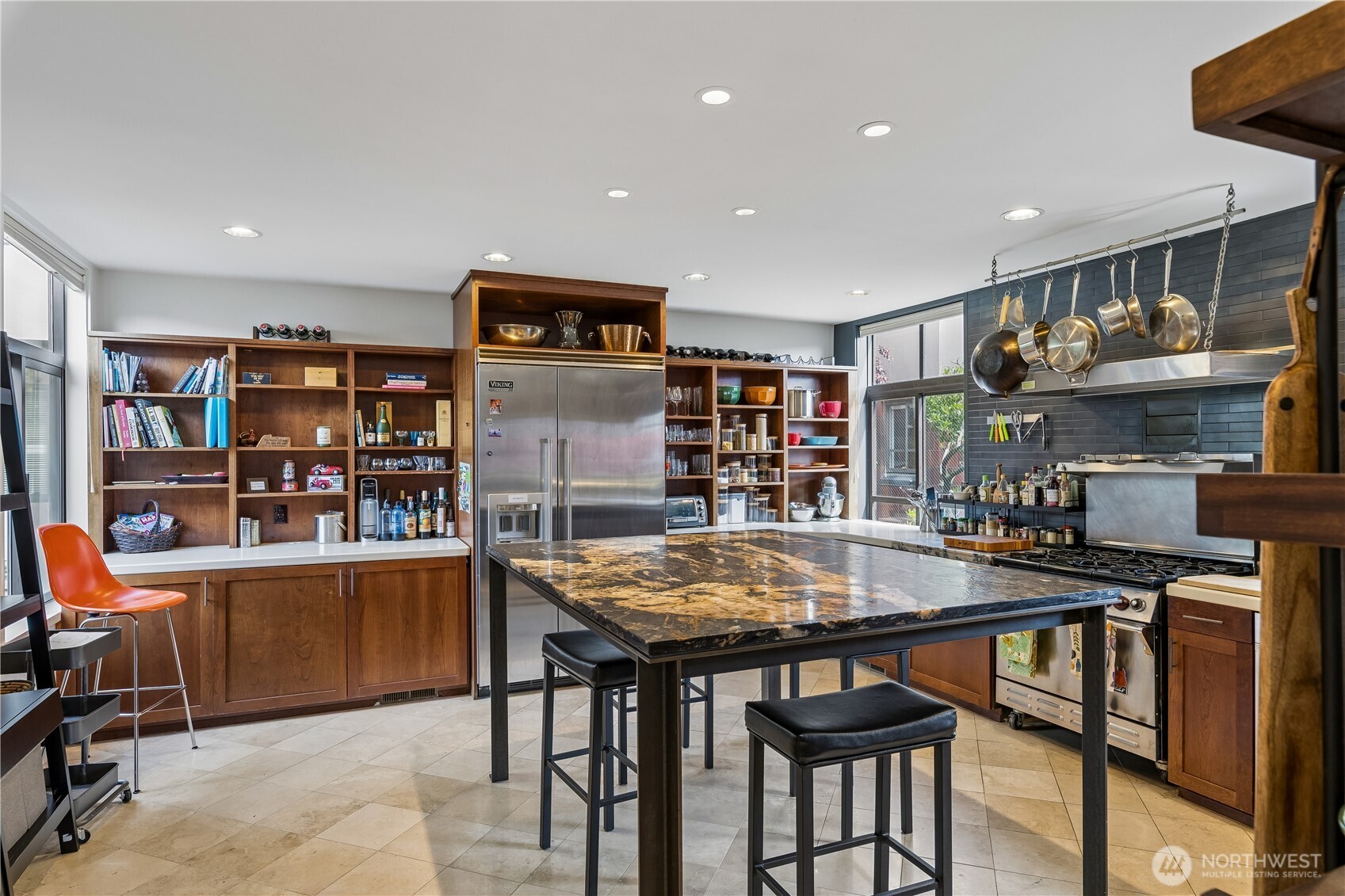88 Virginia Street, Unit 2 Seattle, WA 98121 - Photo 6 of 20 a room with stainless steel appliances lots of wooden furniture a table and chairs in it