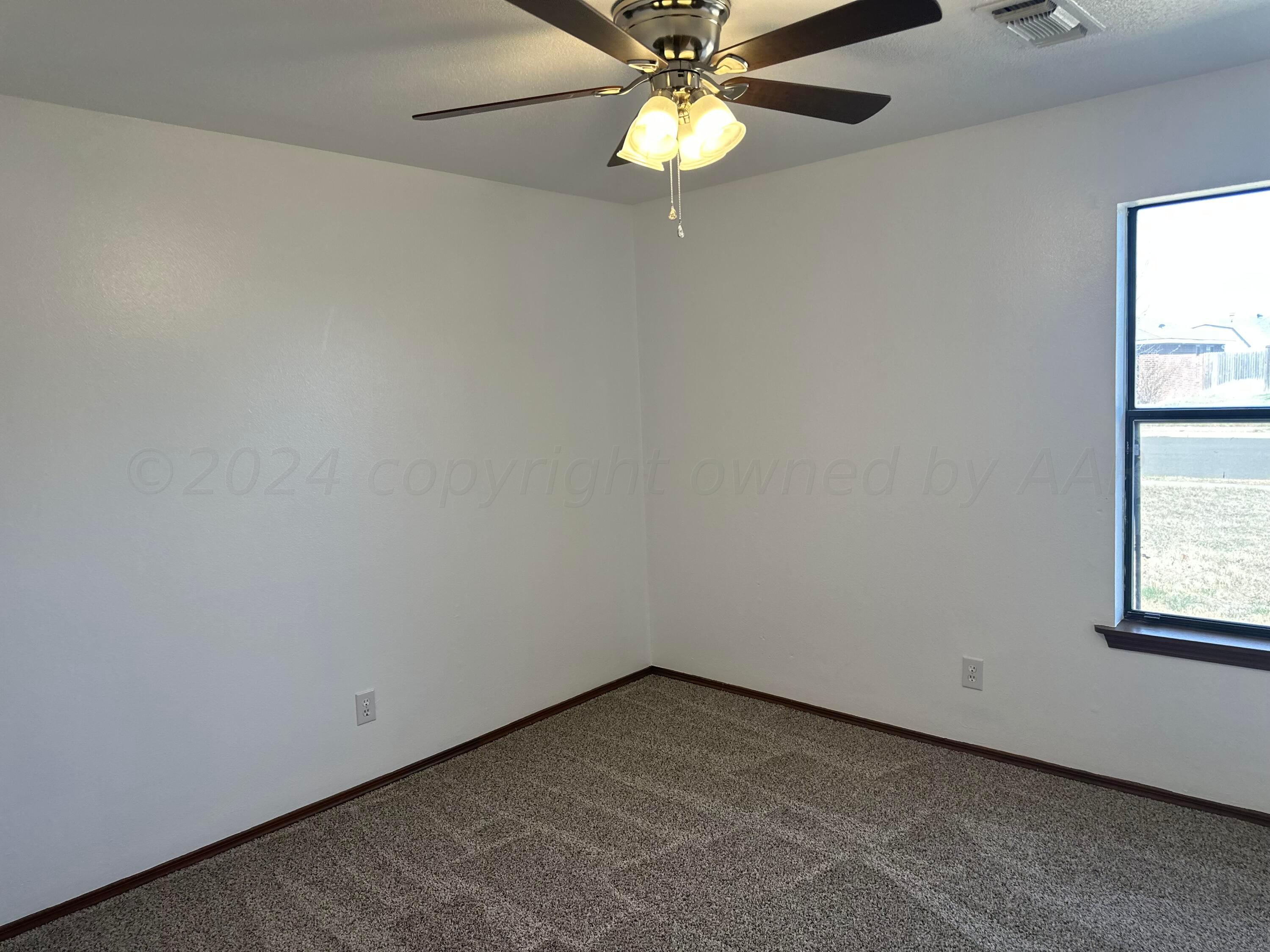 4225 Jamie Trail Amarillo, TX 79110 - Photo 12 of 15 an empty room with a window and a fan
