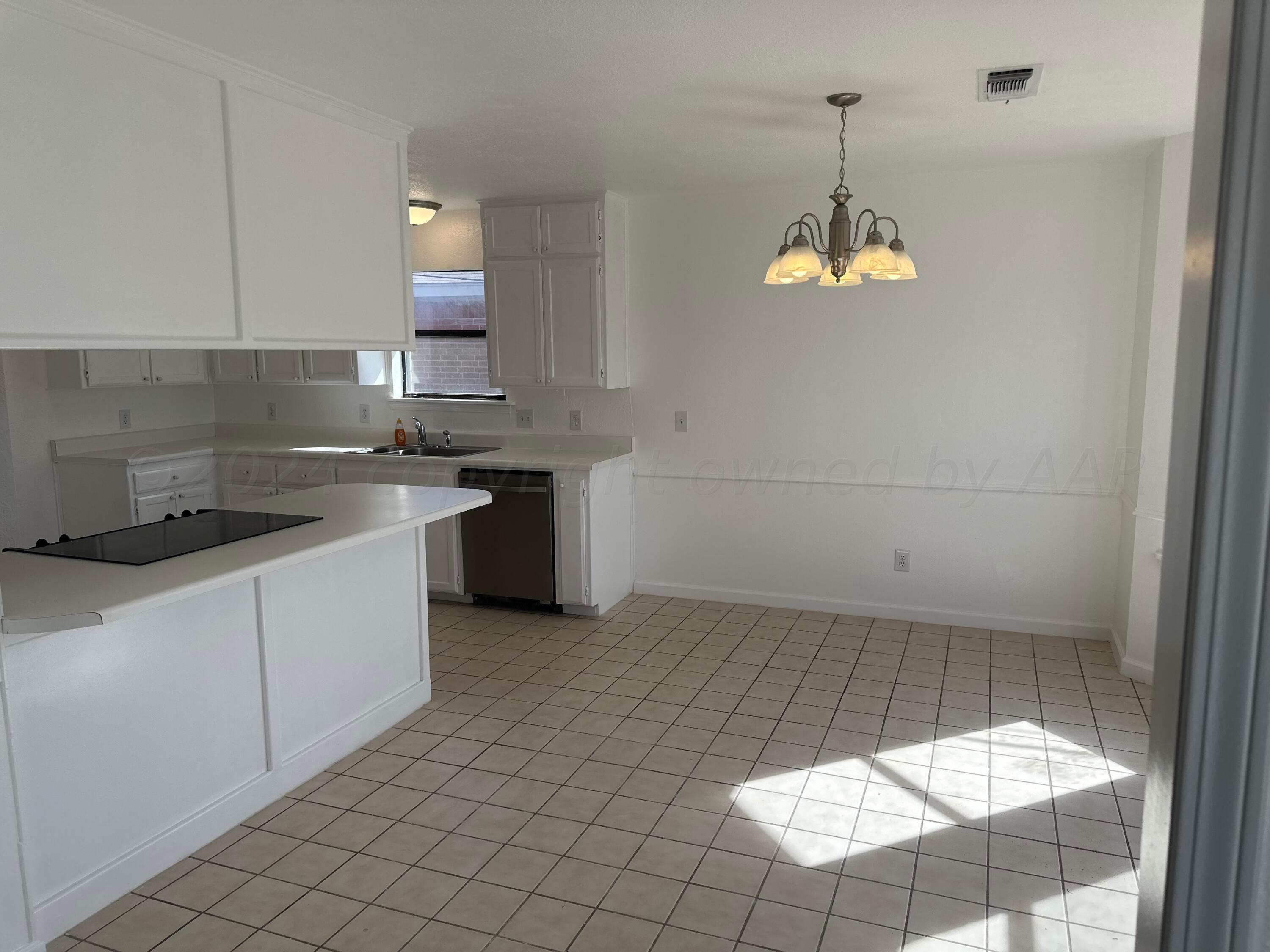 4225 Jamie Trail Amarillo, TX 79110 - Photo 4 of 15 a kitchen with a sink cabinets and window