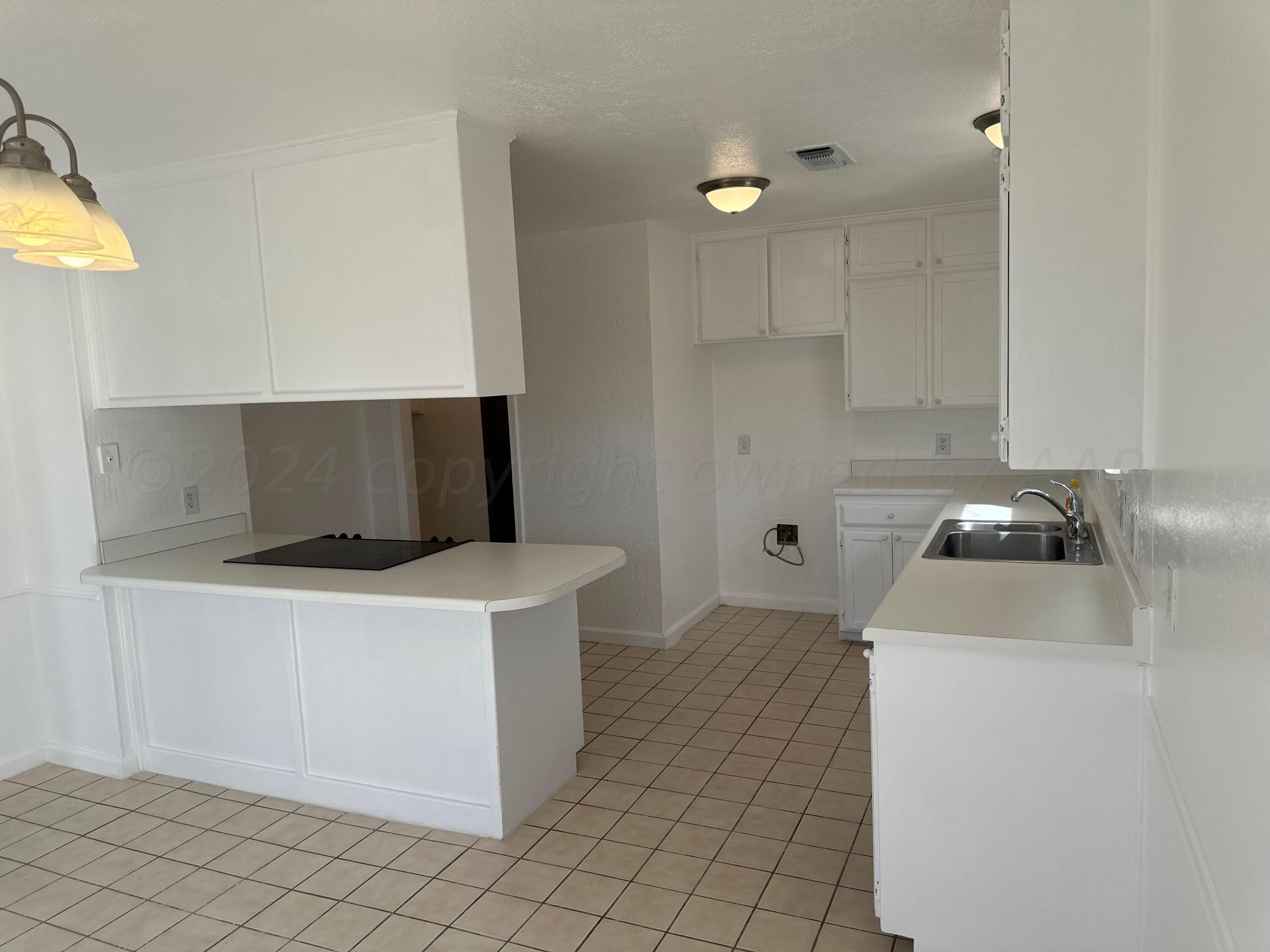 4225 Jamie Trail Amarillo, TX 79110 - Photo 5 of 15 a kitchen that has a sink and a stove