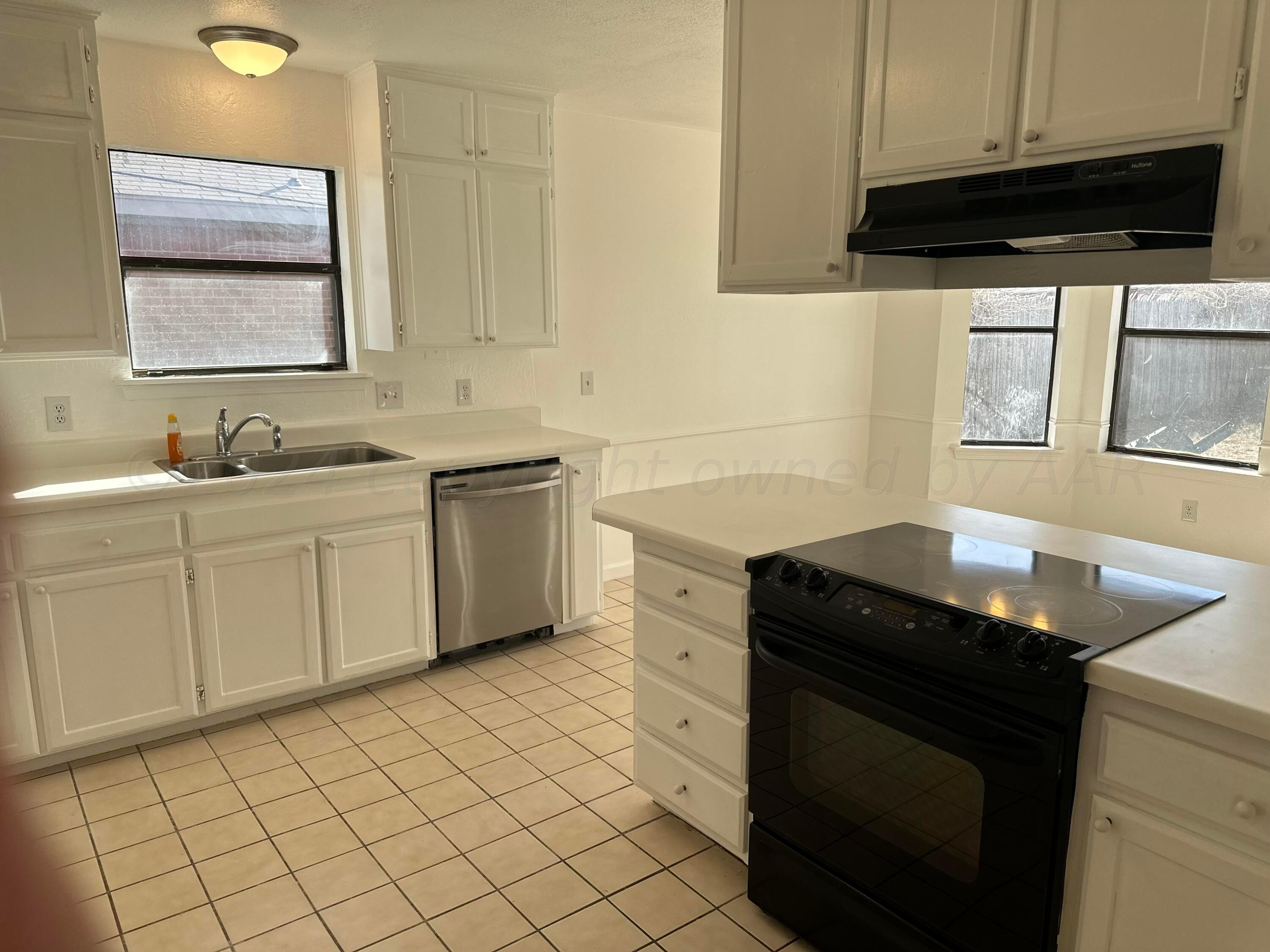 4225 Jamie Trail Amarillo, TX 79110 - Photo 6 of 15 a kitchen with a sink and cabinets