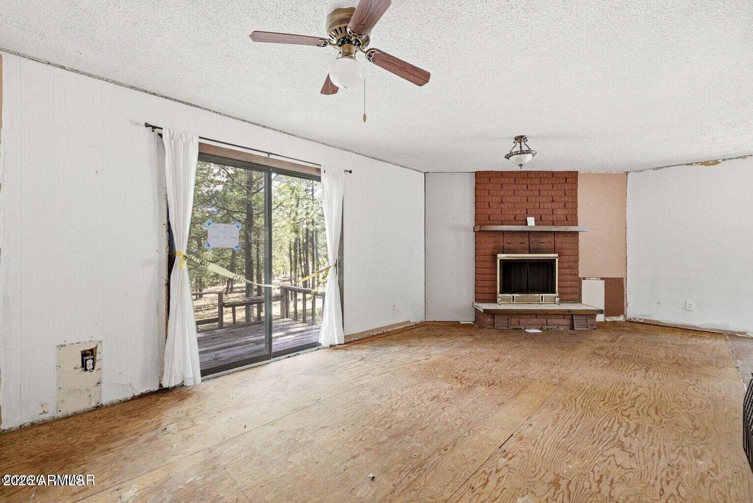 6 South County Rd N2148 Road Alpine, AZ 85920 - Photo 7 of 29 a view of an empty room with window and chandelier fan