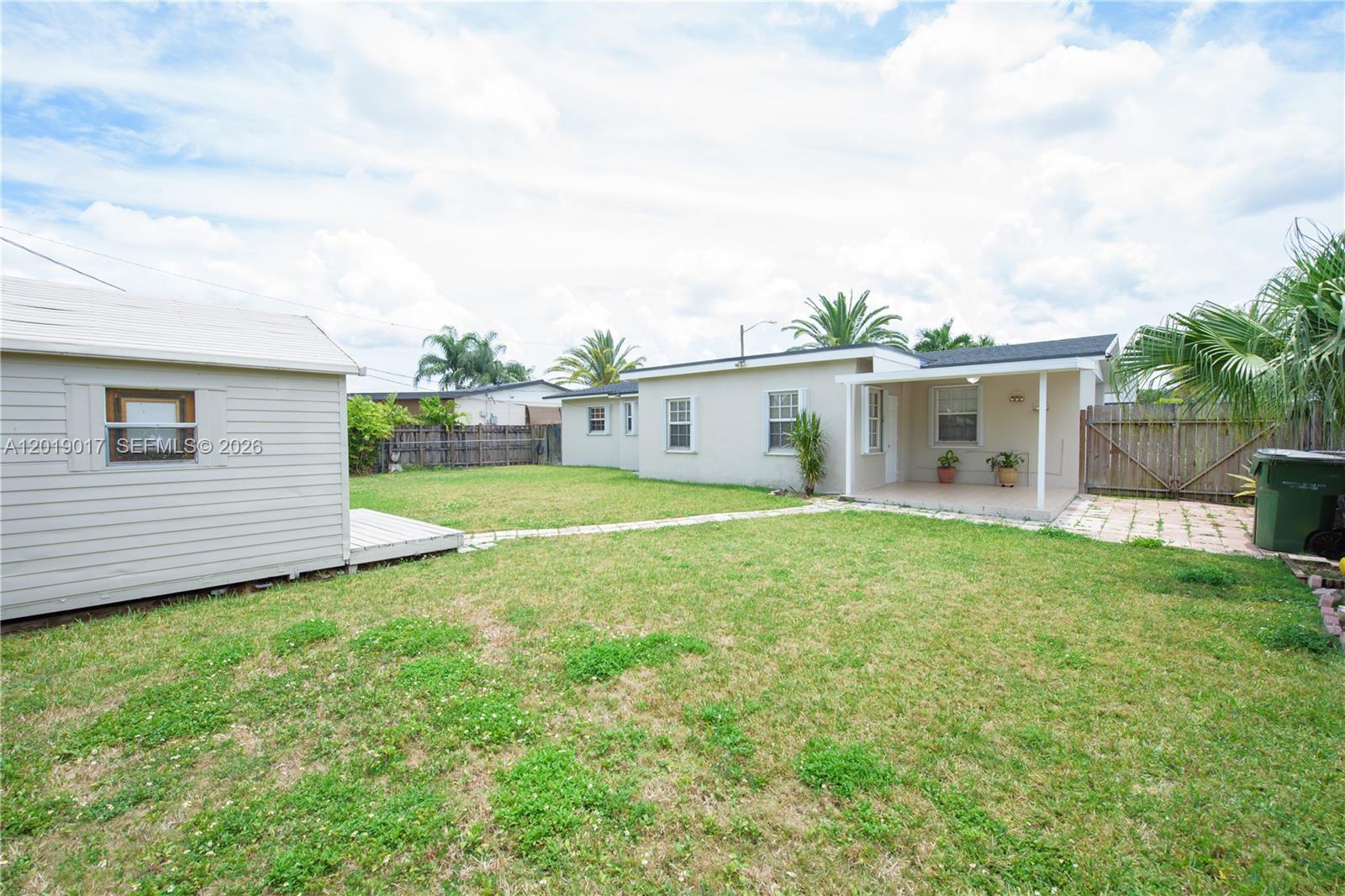 731 Northwest 17th Street Homestead, FL 33030 - Photo 16 of 29 a view of a house with a backyard and a garden