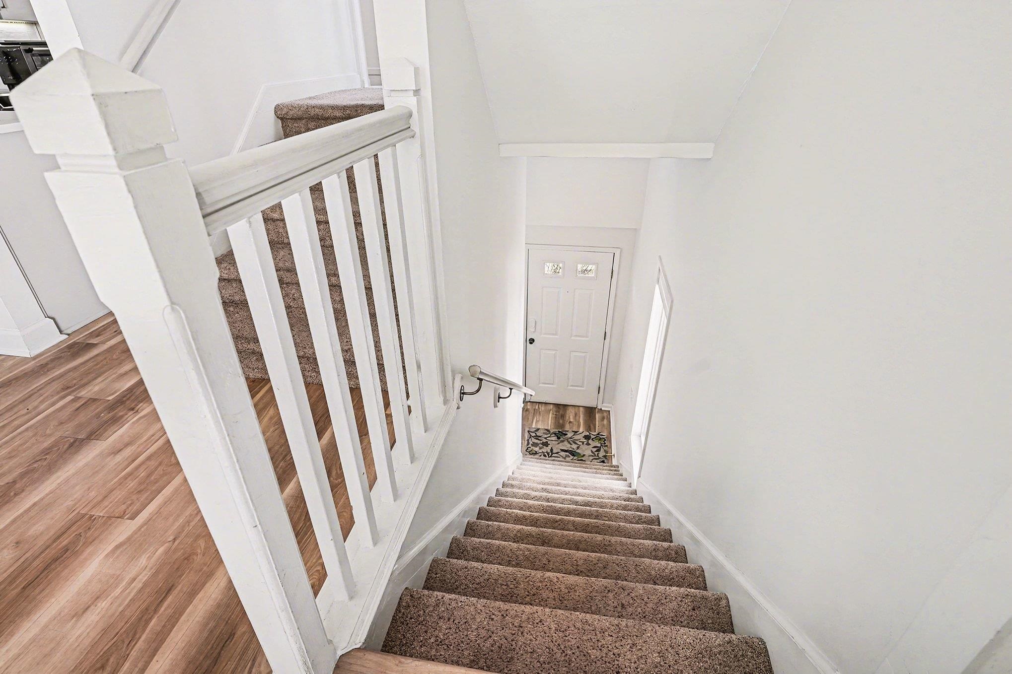 4999 Highway 17 Business, Unit 304D Murrells Inlet, SC 29576 - Photo 13 of 33 Stairway featuring wood finished floors and baseboards