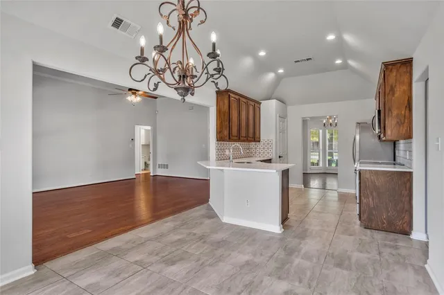 a view of a kitchen with a sink stainless steel appliances and cabinets
