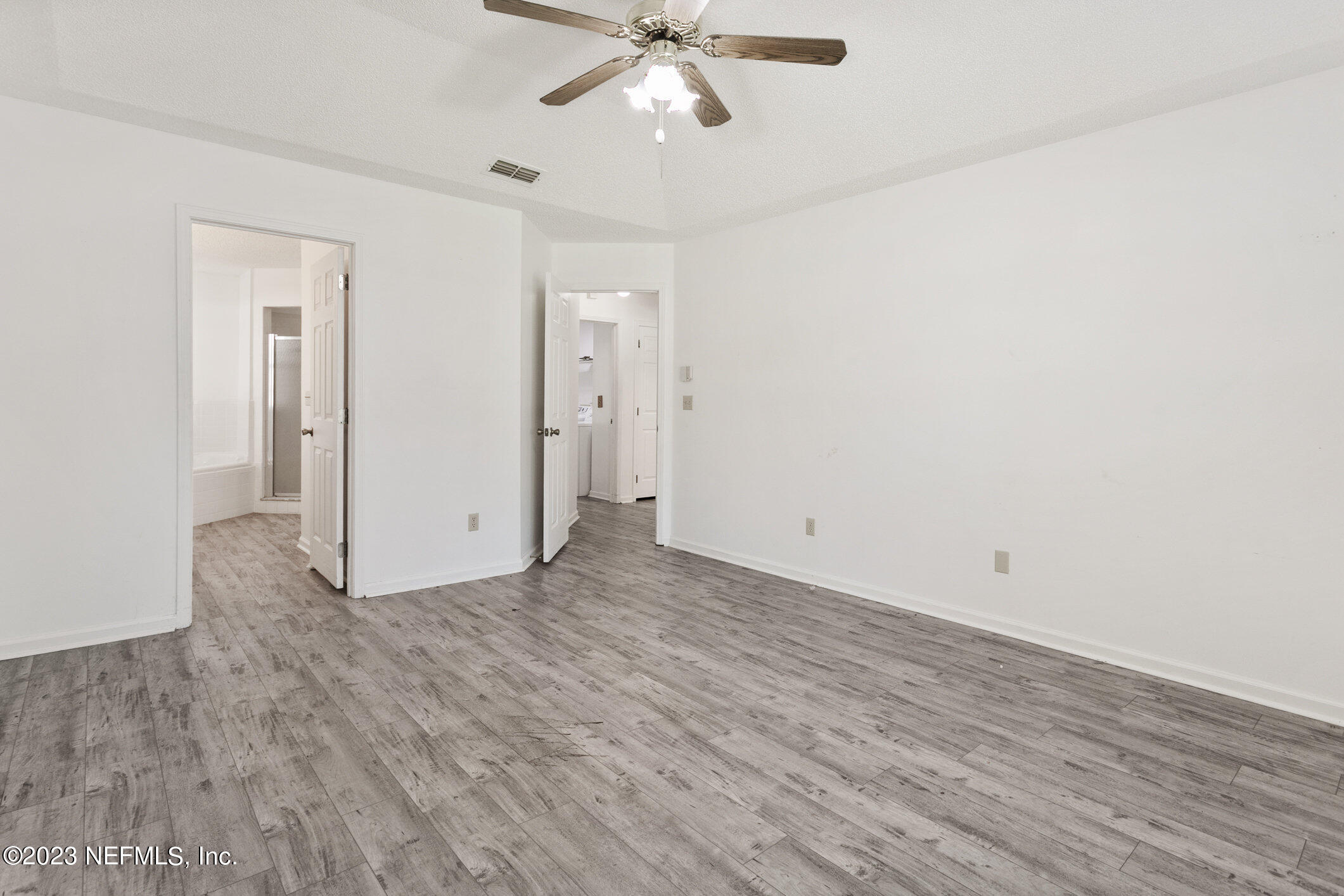 6650 Ricker Road Jacksonville, FL 32244 - Photo 12 of 41 a view of an empty room with wooden floor