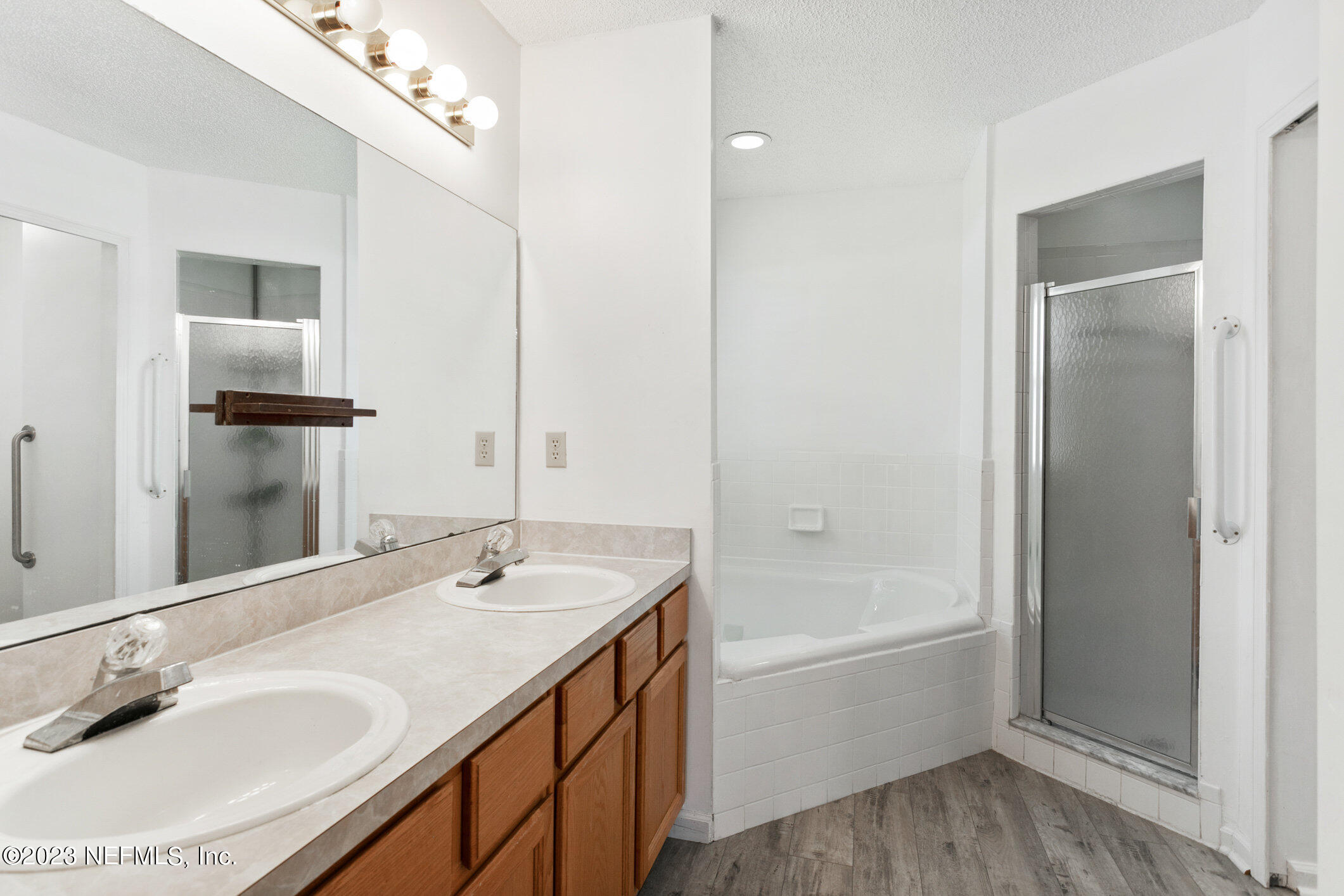 6650 Ricker Road Jacksonville, FL 32244 - Photo 13 of 41 a bathroom with a tub sink and mirror
