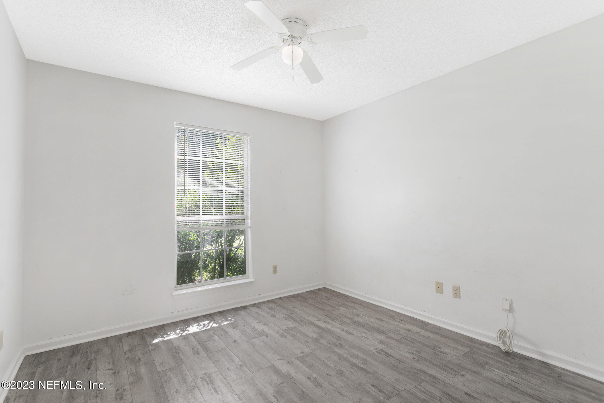 6650 Ricker Road Jacksonville, FL 32244 - Photo 15 of 41 an empty room with a window and wooden floor