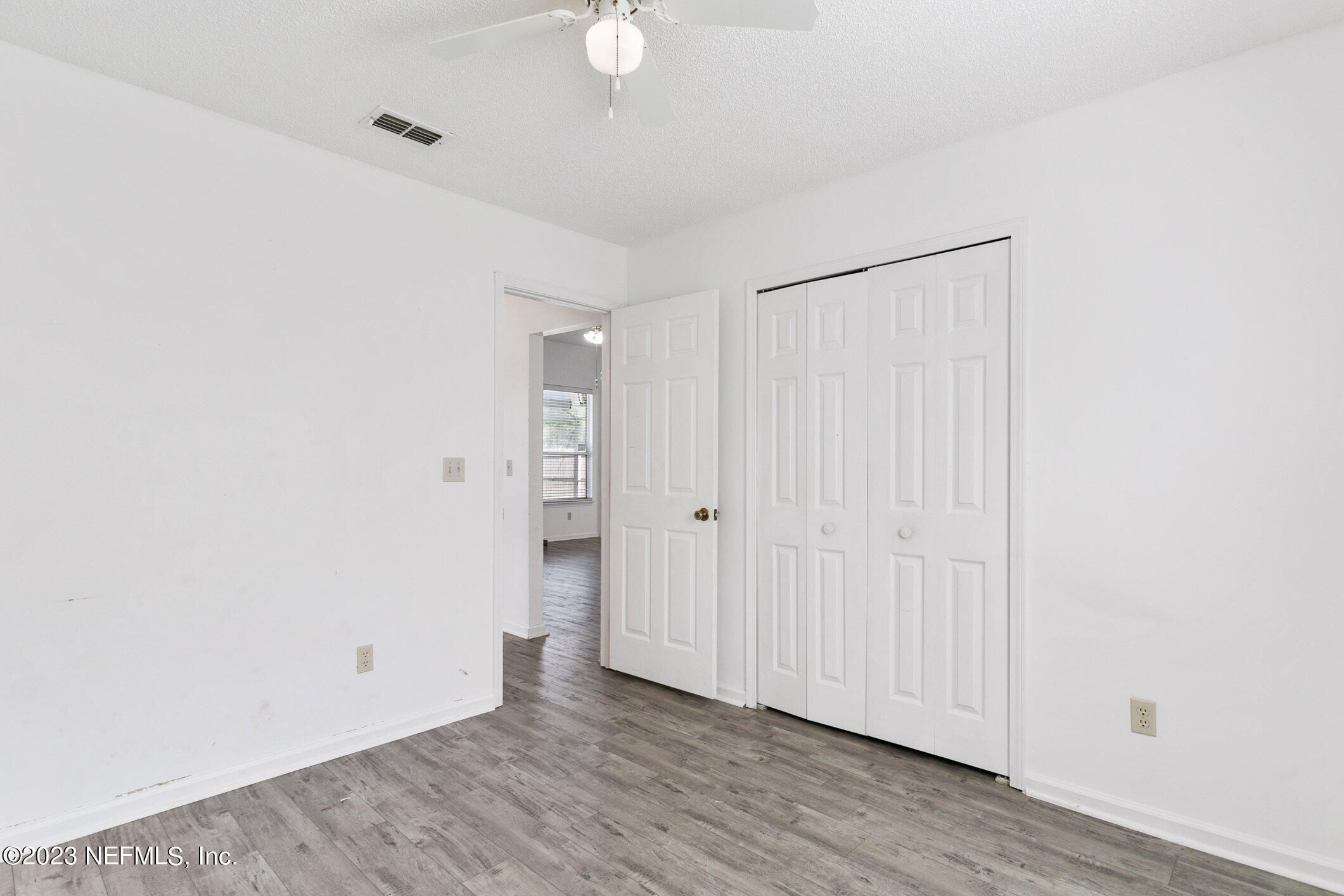 6650 Ricker Road Jacksonville, FL 32244 - Photo 16 of 41 a view of an empty room with wooden floor