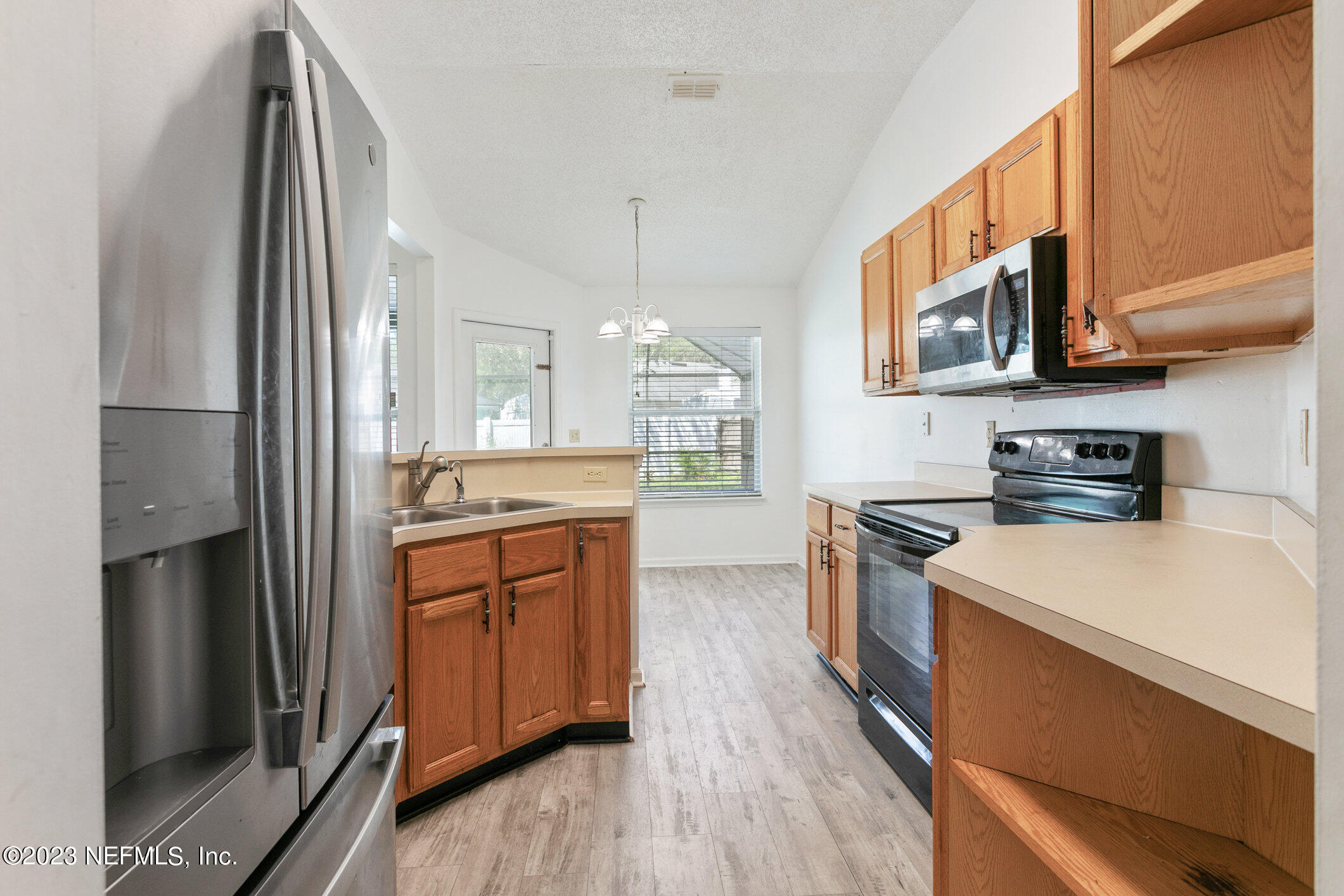 6650 Ricker Road Jacksonville, FL 32244 - Photo 21 of 41 a large kitchen with stainless steel appliances granite countertop a stove a sink and a refrigerator