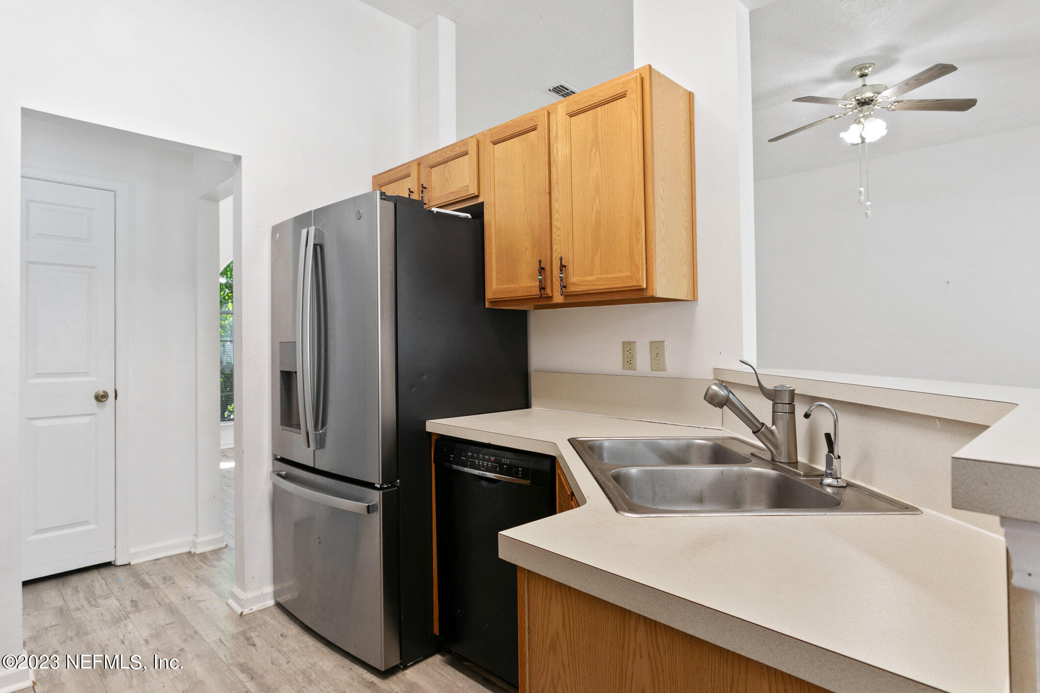 6650 Ricker Road Jacksonville, FL 32244 - Photo 24 of 41 a kitchen with a sink a refrigerator and cabinets