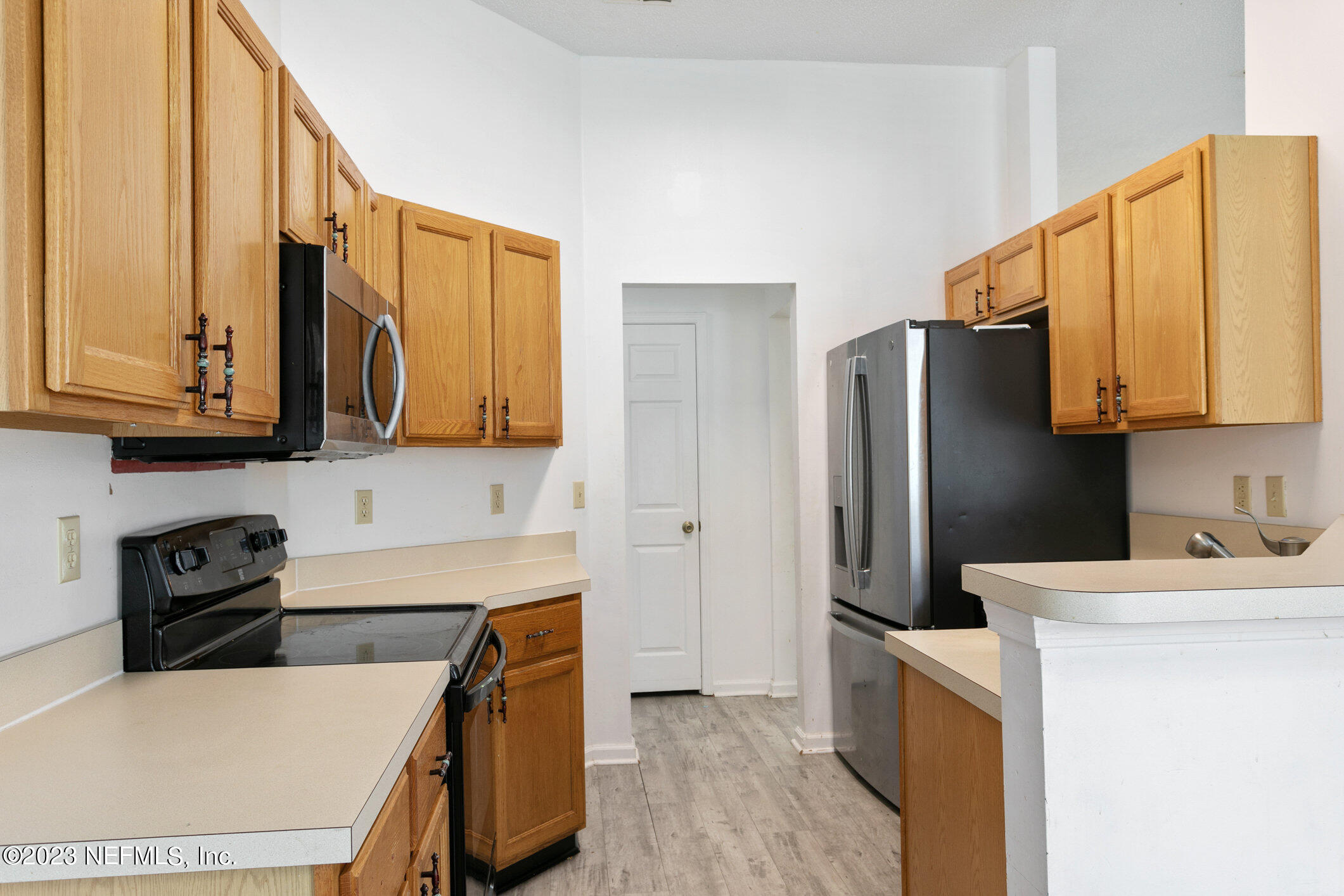 6650 Ricker Road Jacksonville, FL 32244 - Photo 25 of 41 a kitchen with stainless steel appliances a stove refrigerator sink and cabinets