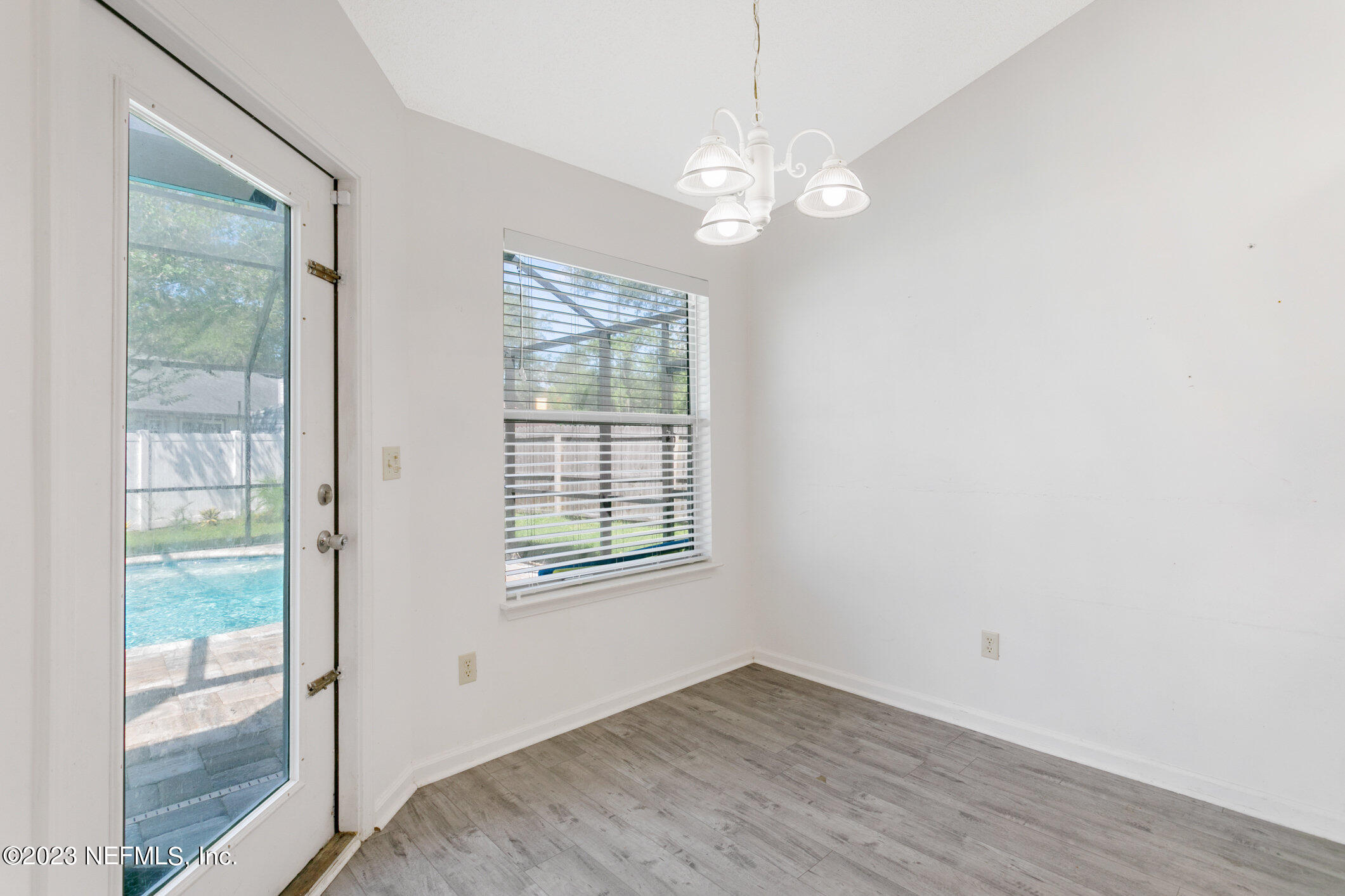 6650 Ricker Road Jacksonville, FL 32244 - Photo 27 of 41 an empty room with wooden floor and windows
