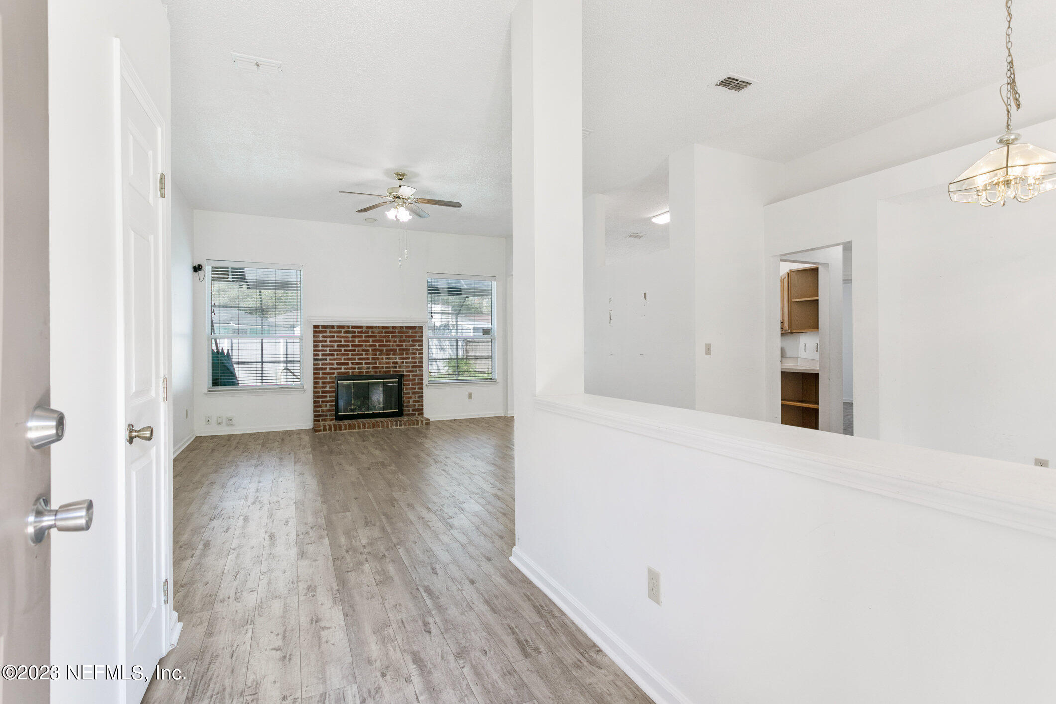 6650 Ricker Road Jacksonville, FL 32244 - Photo 4 of 41 wooden floor in an empty room with a fireplace