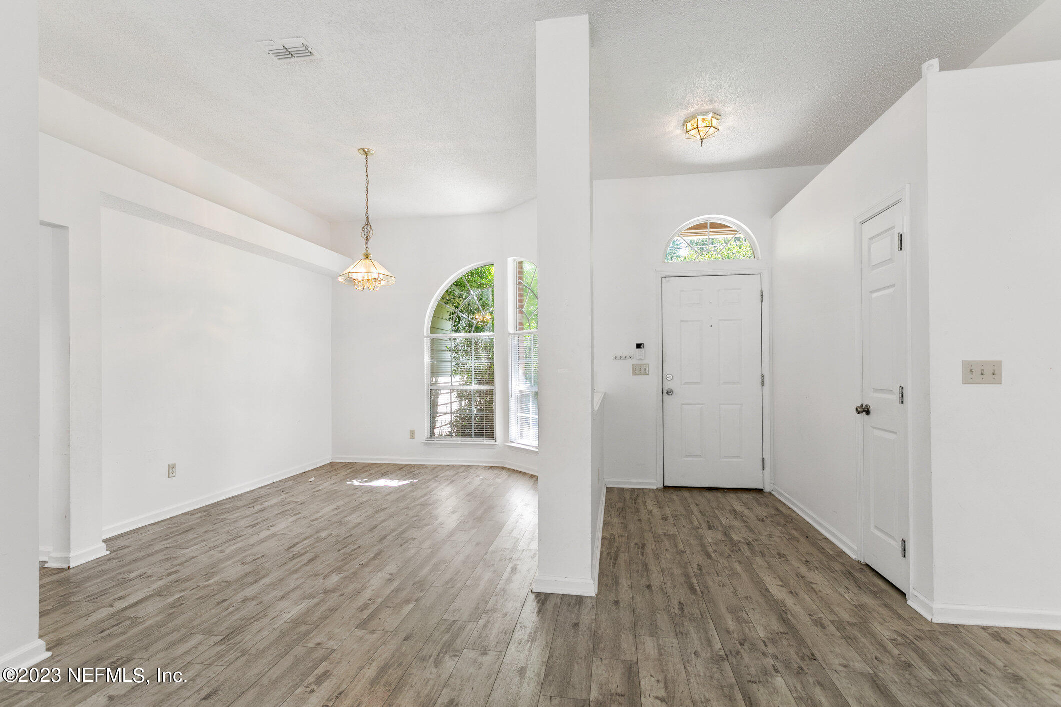 6650 Ricker Road Jacksonville, FL 32244 - Photo 6 of 41 a view of an empty room with wooden floor and a window