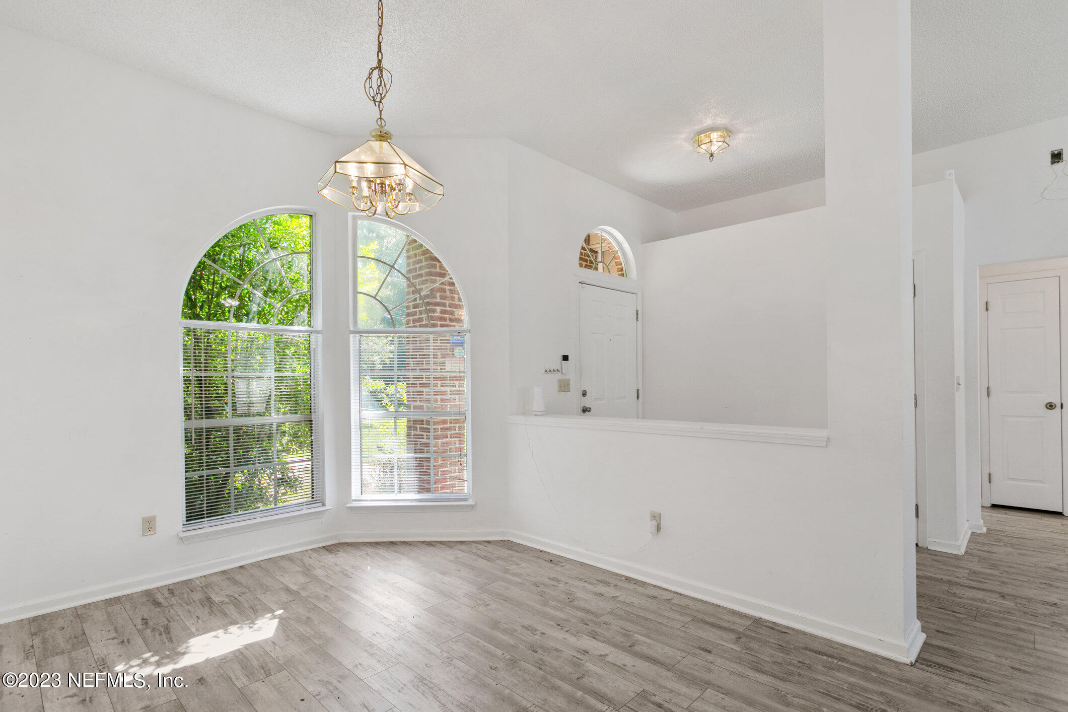 6650 Ricker Road Jacksonville, FL 32244 - Photo 7 of 41 a view of an empty room with wooden floor and a window