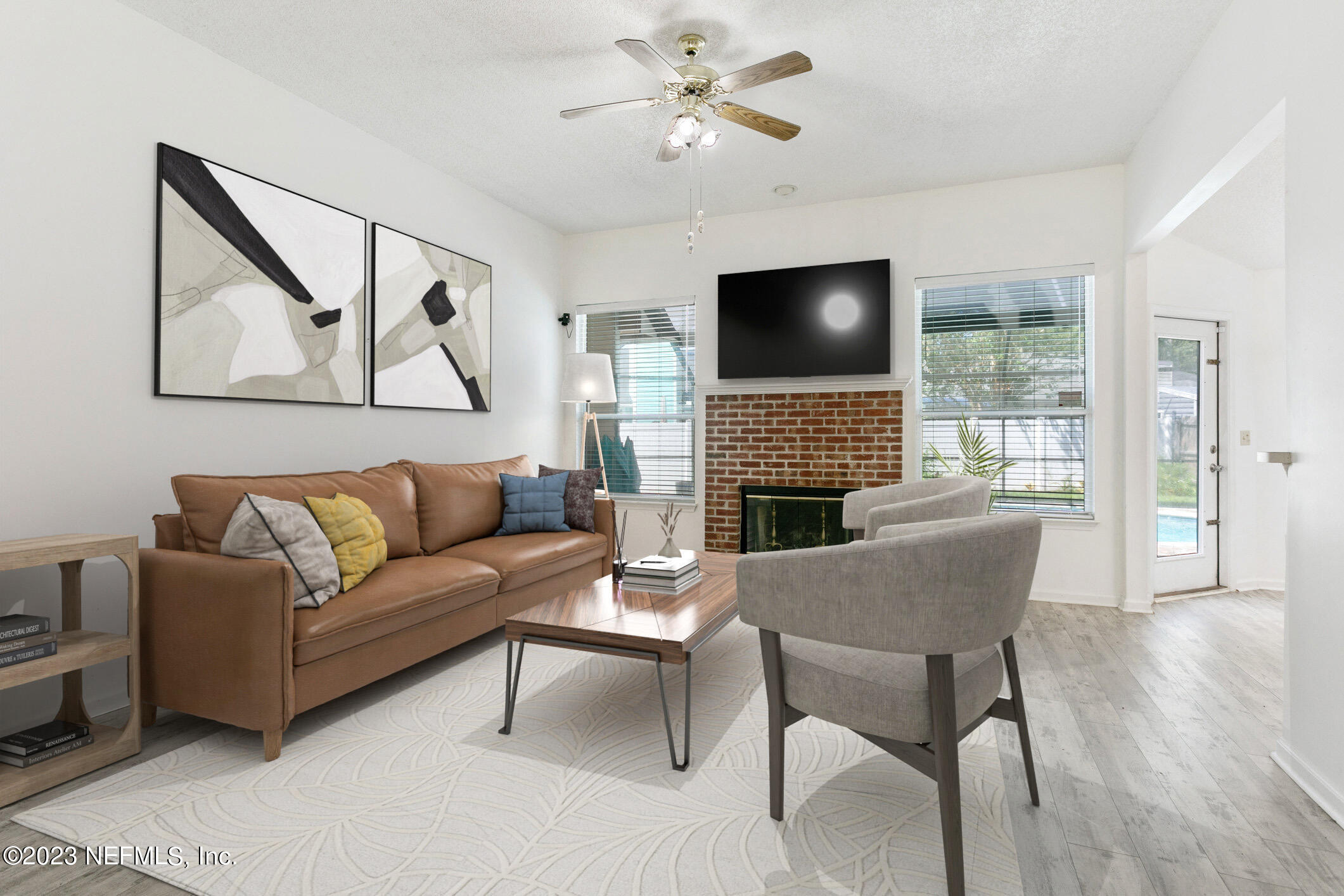 6650 Ricker Road Jacksonville, FL 32244 - Photo 9 of 41 a living room with furniture a flat screen tv and a fireplace