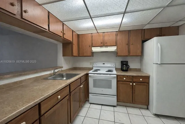 a kitchen with a sink appliances and cabinets