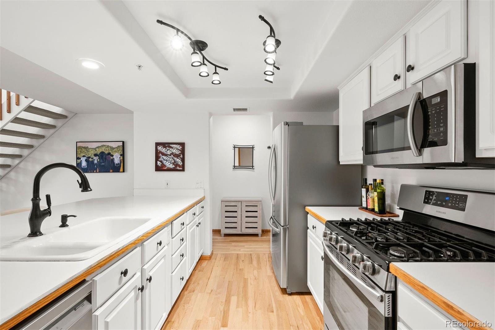 a large kitchen with stainless steel appliances granite countertop a stove and a sink