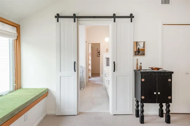 a view of a room that has a bed and a mirror