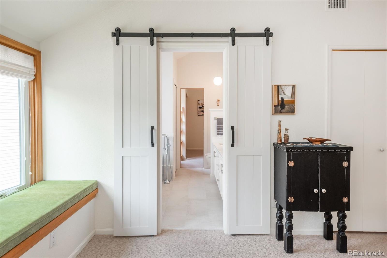 23624 Pondview Place, Unit G Golden, CO 80401 - Photo 13 of 33 a view of a room that has a bed and a mirror