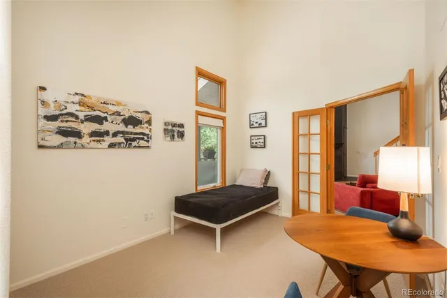 a living room with a bed and a window