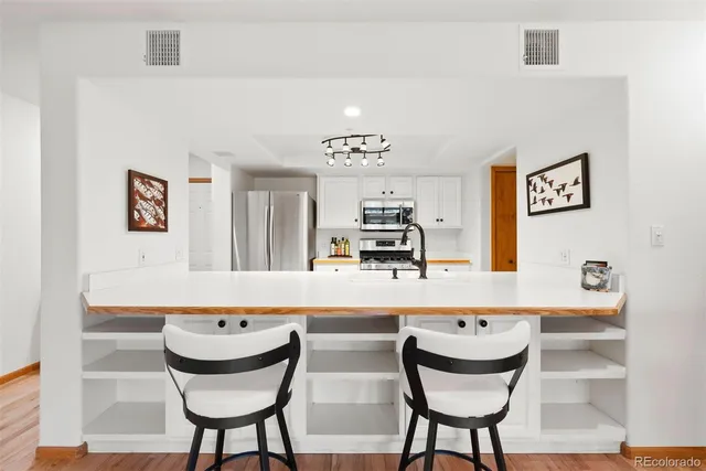 a living room with dining room and kitchen view