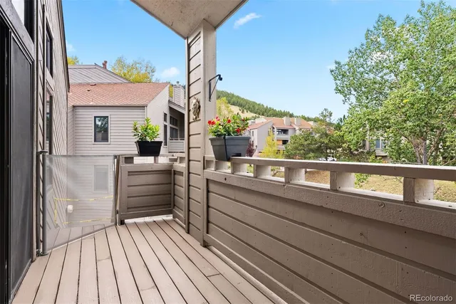 a view of a balcony with two chairs and a table