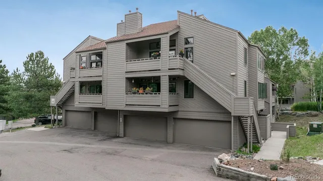 a view of a house with a yard and parking space
