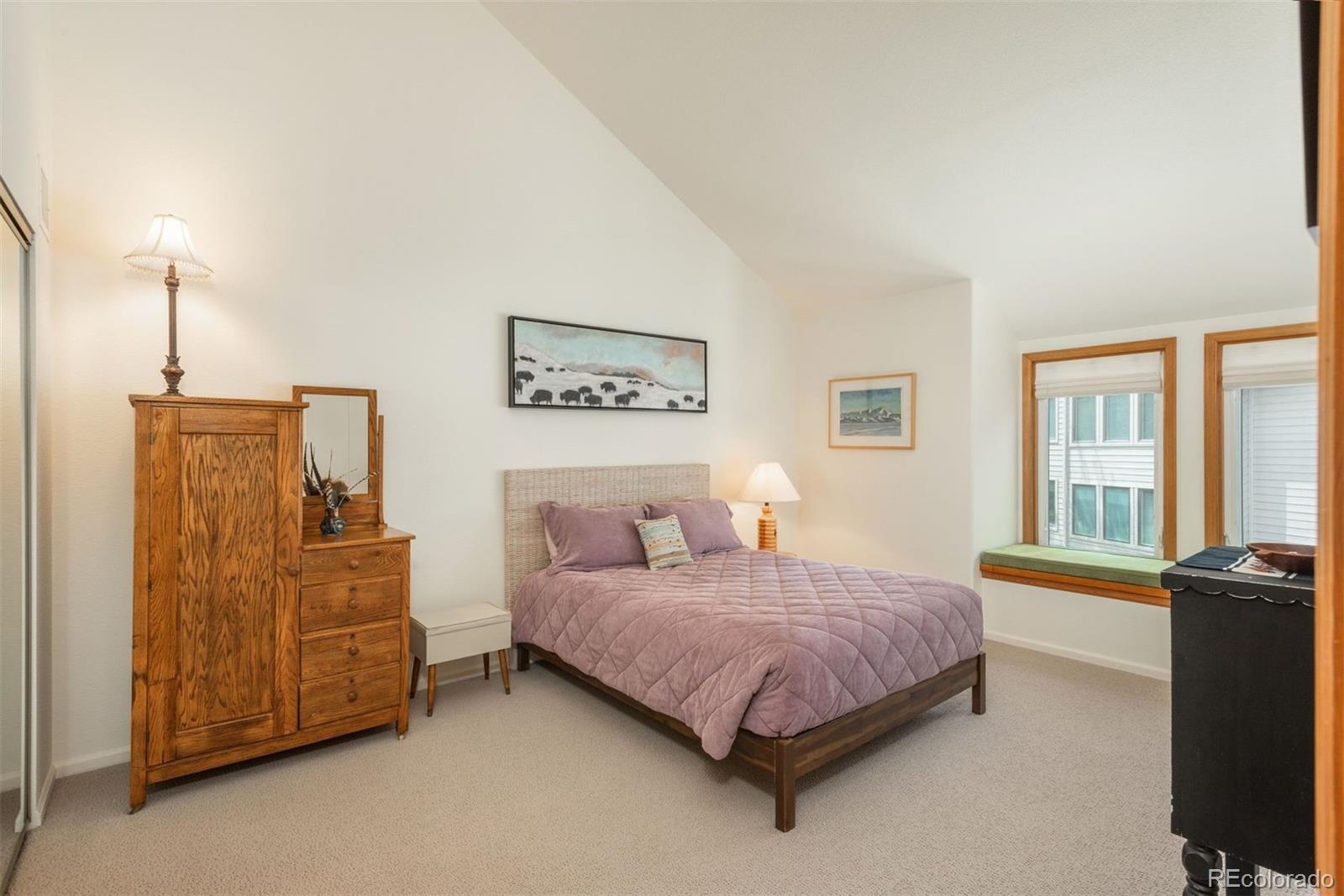 23624 Pondview Place, Unit G Golden, CO 80401 - Photo 10 of 33 a bedroom with a bed dresser and wooden floor