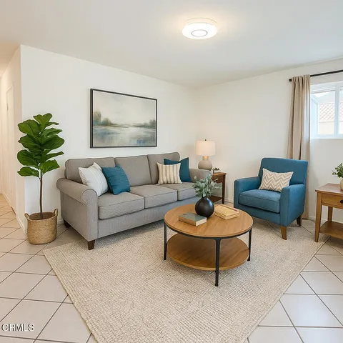 a living room with furniture and a potted plant